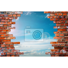 Фотообои с видом на облака через кирпичную стену