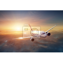Фотообои с самолетом в облаках на закате солнца